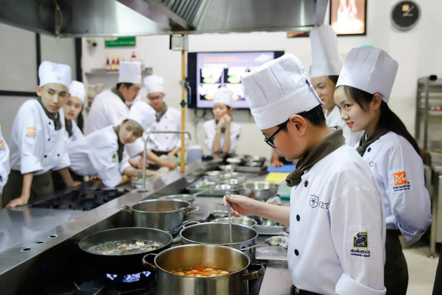 Culinary students learn to cook in a professional kitchen.